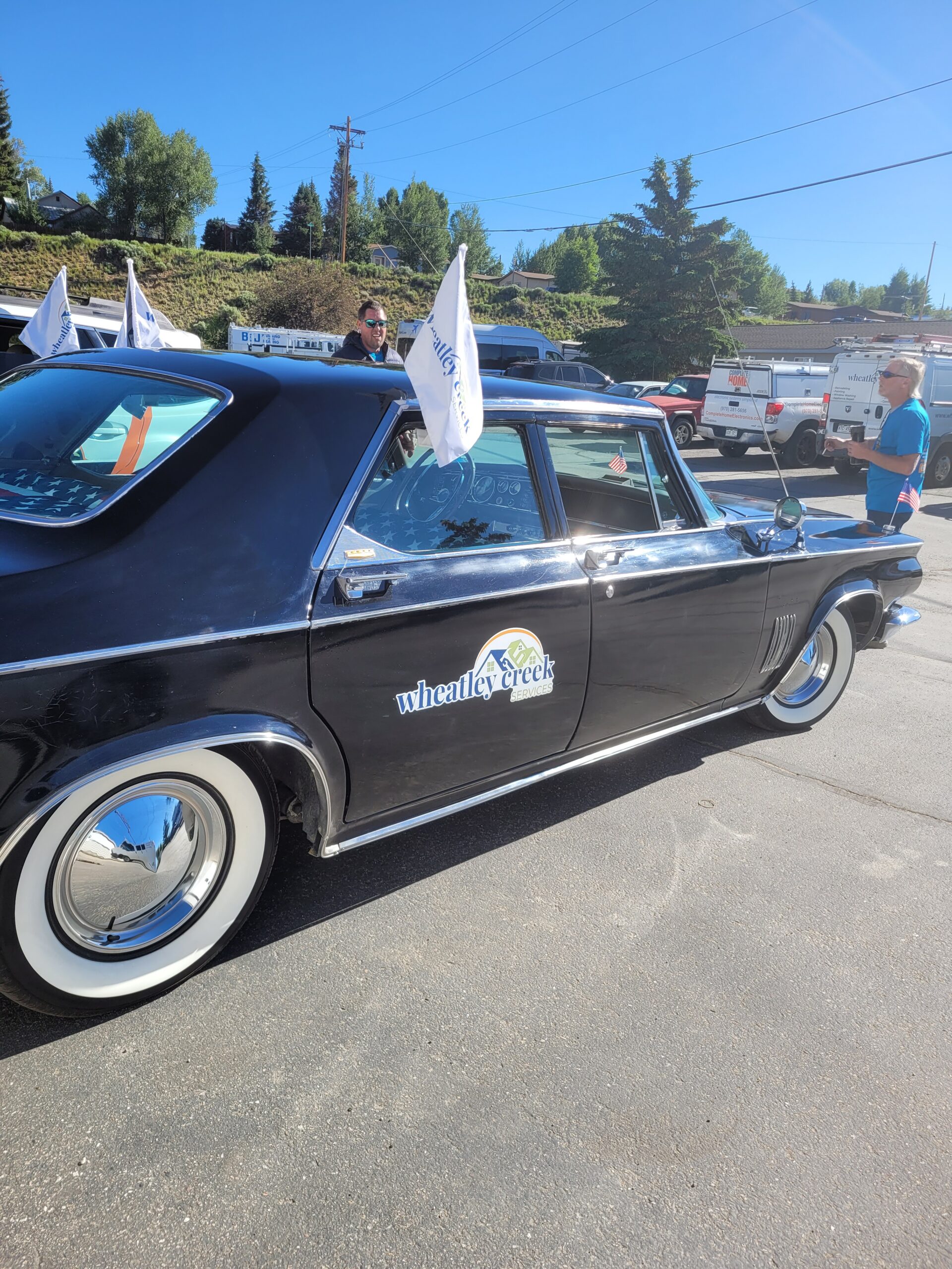 Wheatley Creek Services classic car decked out with flags for the 4th of July parade in Granby Colorado