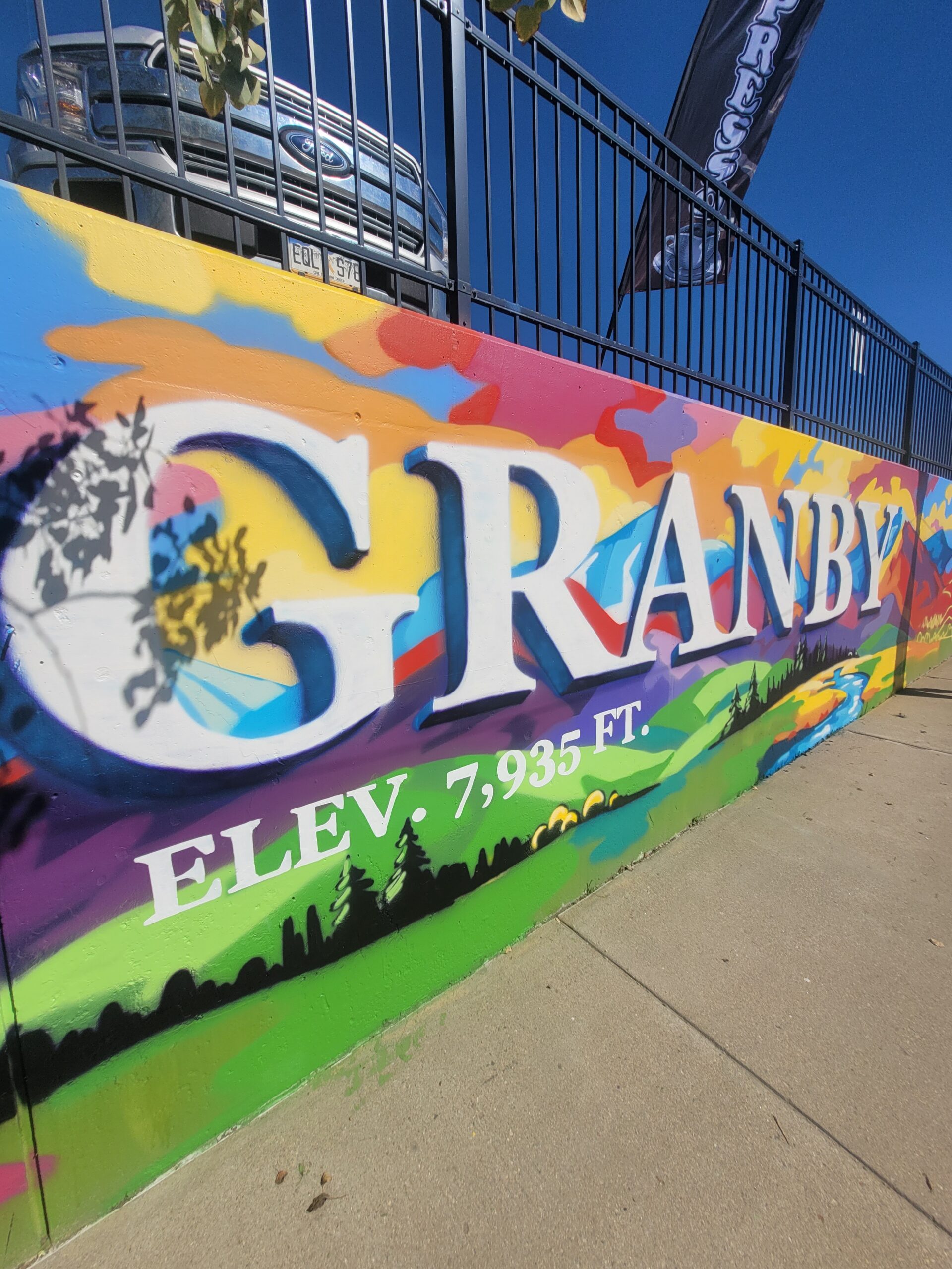 Colorful Granby mural celebrating Art in the Park